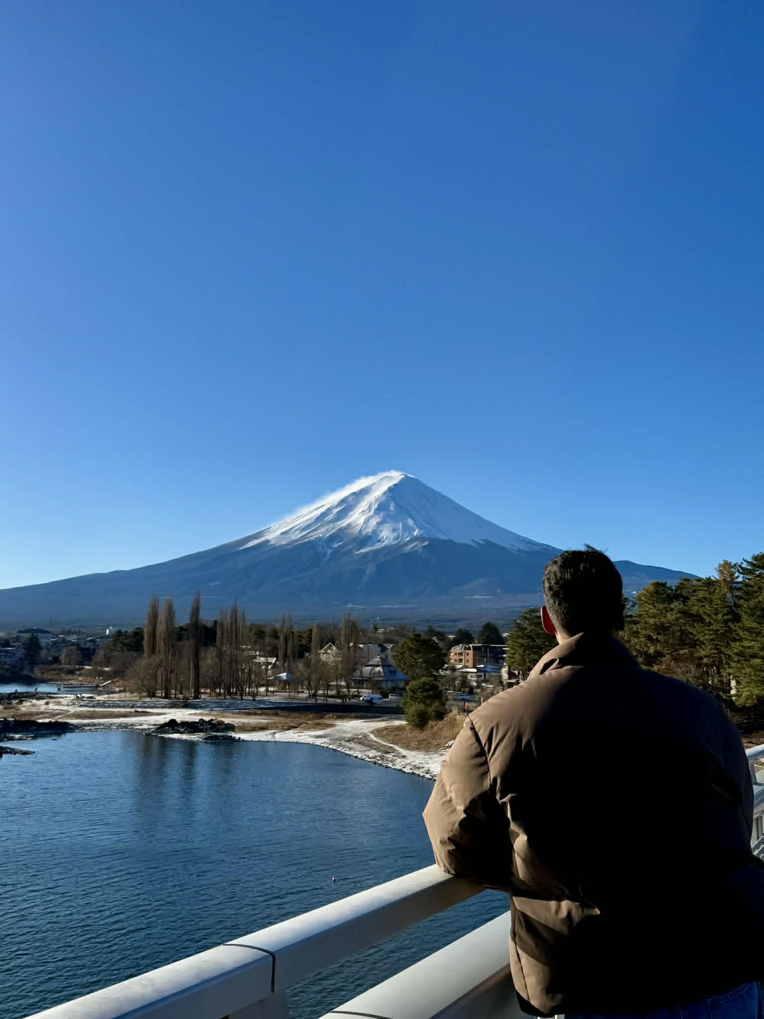 Mt. Fuji's snow-capped peak across Lake Kawaguchiko, viewed from the Ōhashi Bridge in winter